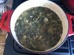 A Dutch oven filled with three pounds of greens cooks down quickly, though not yet tender.